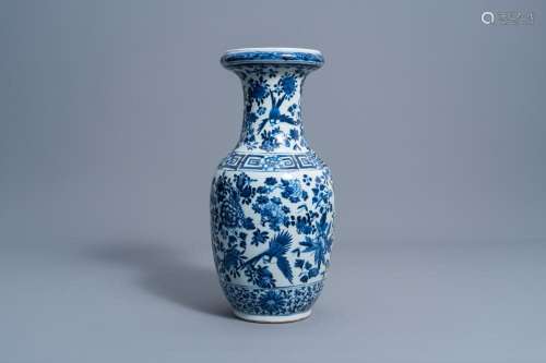 A CHINESE BLUE AND WHITE VASE WITH BIRDS AMONG BLOSSOMING BR...