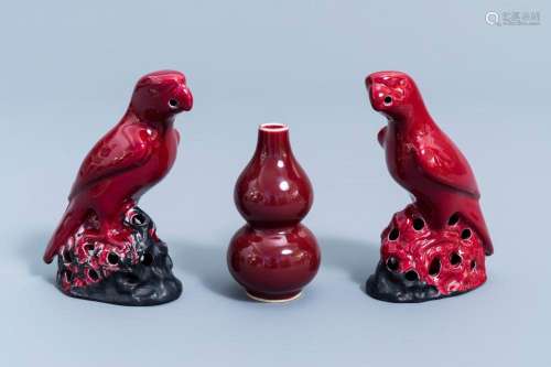 A PAIR OF CHINESE RED GLAZED PARROTS AND A MONOCHROME RED DO...