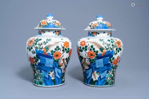 A PAIR OF CHINESE WUCAI VASES AND COVERS WITH BIRDS AMONG BL...