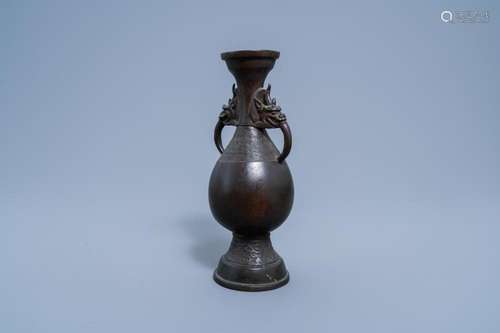 A CHINESE BRONZE VASE WITH HANDLES IN THE SHAPE OF MYTHICAL ...