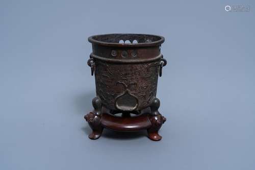 A CHINESE BRONZE BRUSH POT ON WOODEN STAND, QING