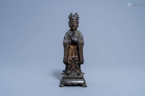 A CHINESE PARTLY GILT AND LACQUERED BRONZE FIGURE OF A DIGNI...