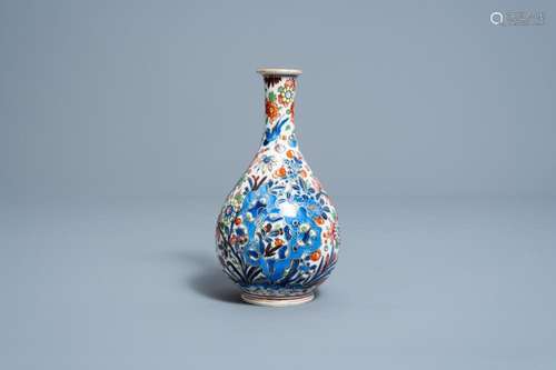 A CLOBBERED CHINESE BLUE AND WHITE VASE WITH BIRDS AMONG FLO...