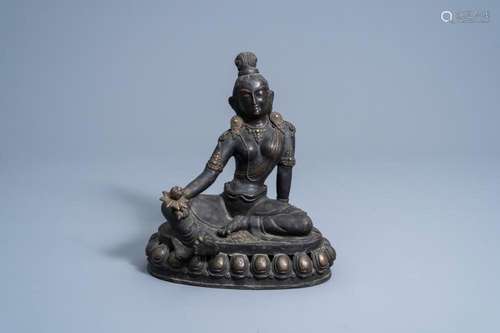 A SINO-TIBETAN BRONZE FIGURE OF TARA HOLDING A LOTUS, 19TH/2...