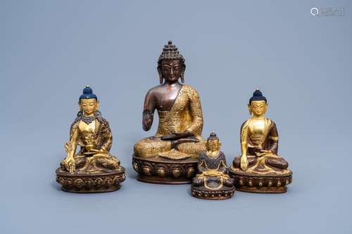 FOUR SINO-TIBETAN PARTLY GILT BRONZE FIGURES OF BUDDHA, 20TH...