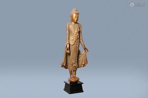 A TALL INLAID GILT WOOD FIGURE OF A STANDING BUDDHA, THAILAN...