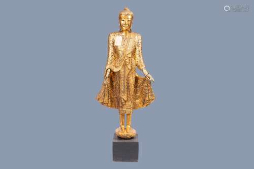 A TALL INLAID GILT WOOD FIGURE OF A STANDING BUDDHA, THAILAN...