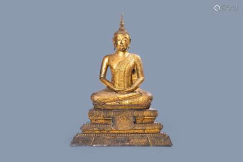 A LARGE THAI GILT LACQUERED BRONZE FIGURE OF BUDDHA ON A LOT...