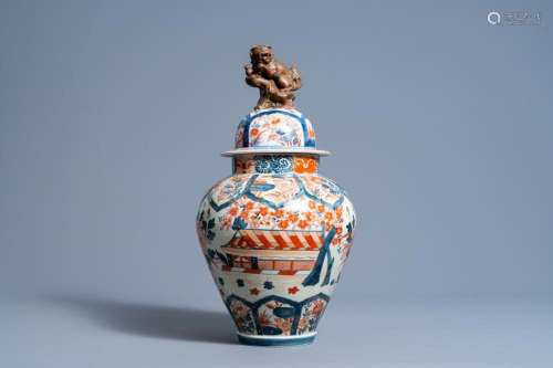 A JAPANSE IMARI VASE AND COVER WITH LANDSCAPES AND FLORAL DE...