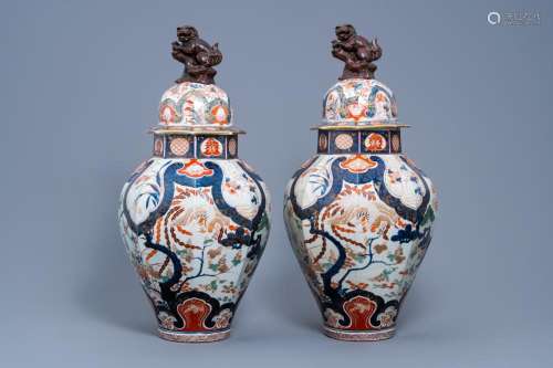 A PAIR OF LARGE JAPANESE IMARI VASES AND COVERS WITH A PHOEN...