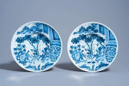 A PAIR OF DUTCH DELFT BLUE AND WHITE CHINOISERIE CHARGERS BY...