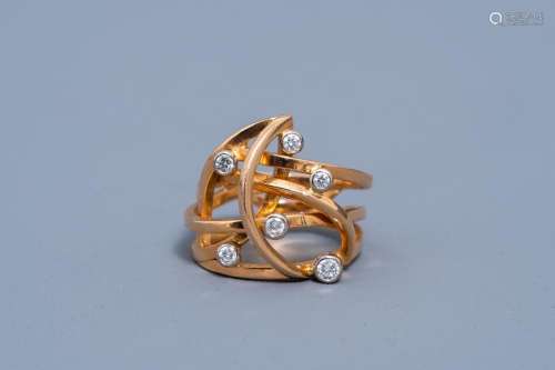 AN 18 CARAT YELLOW AND WHITE GOLD RING SET WITH SIX DIAMONDS...