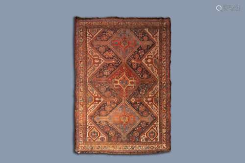 A CAUCASIAN RUG WITH GEOMETRIC PATTERNS AND FLORAL DESIGN, W...
