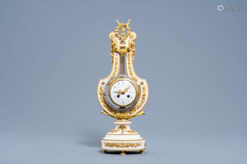 A FRENCH NEOCLASSICAL GILT BRONZE AND WHITE MARBLE LYRE CLOC...