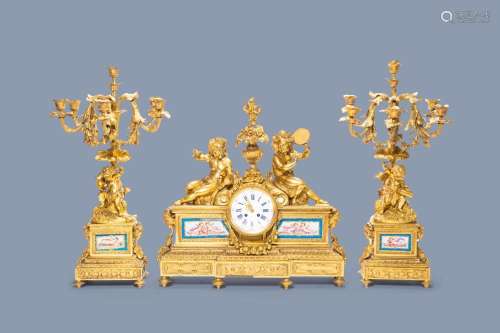 A FRENCH GILT BRONZE THREE-PIECE CLOCK GARNITURE WITH MUSICI...