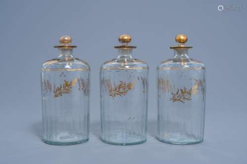 THREE FRENCH CUT GLASS FLASKS AND COVERS WITH GILT FLORAL DE...