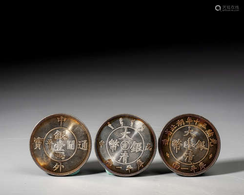 A SET OF THREE SILVER COINS, QING DYNASTY