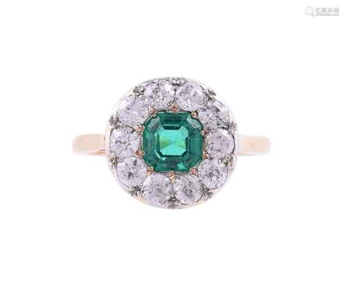 AN EMERALD AND DIAMOND CLUSTER RING