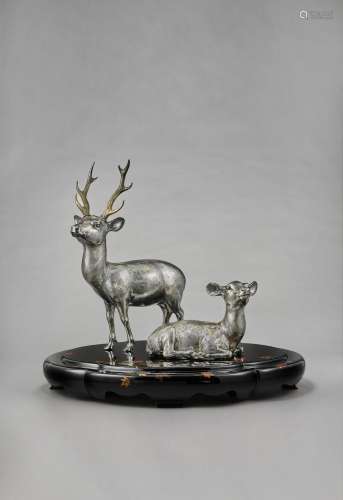 A PAIR OF SILVER SCULPTURES OF A STAG AND A DOE