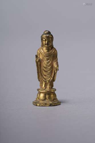 A GILT-BRONZE STANDING SCULPTURE OF BUDDHA