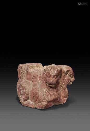 A RARE MOTTLED RED SANDSTONE LION CAPITAL