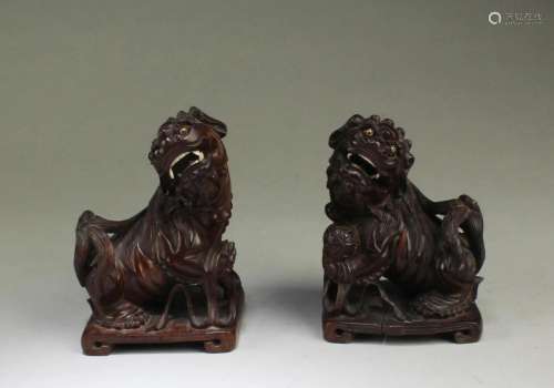 A Pair of Carved Wooden Mythical Beast Figurines A Pair of C...