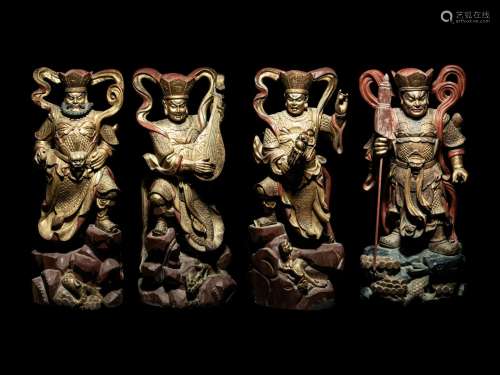 A Set of Four Gilt and Red Lacquered Wood Figures of Guardia...