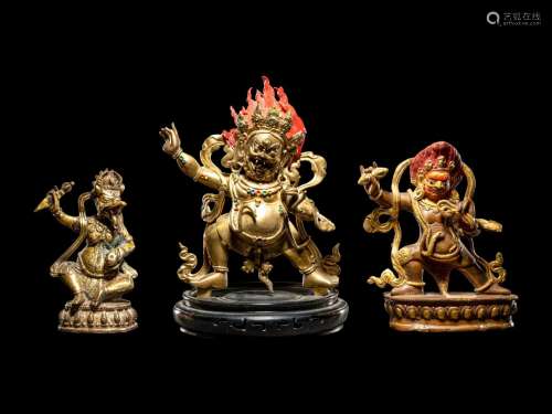 Three Tibetan Gilt Bronze Figures of Guardians Height of tal...
