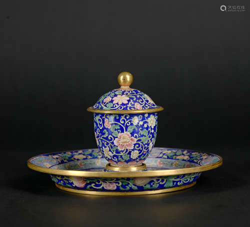 An enamel 'floral' tea cup and holder