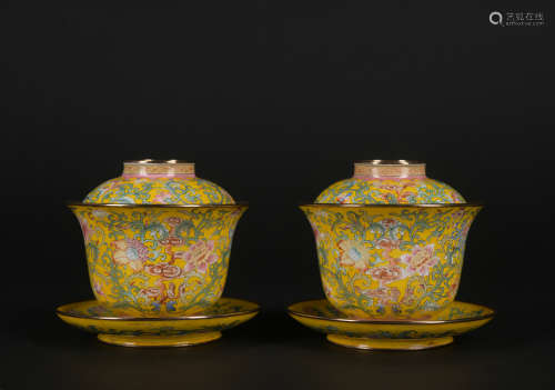 A pair of enamel 'floral' tea cup and holder