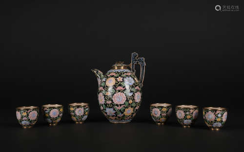 A set of enamel 'floral' tea cup and holder
