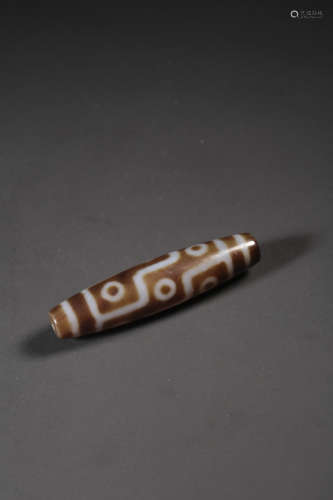 A NINE-EYED DZI BEAD