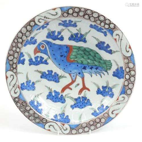 Turkish Iznik pottery plate hand painted with a bird amongst...