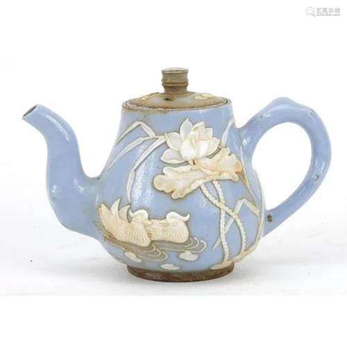 Chinese mauve ground porcelain teapot decorated in relief wi...