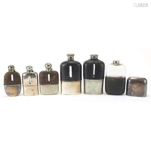 Six antique and later hip flasks, five with leather mounts, ...