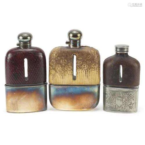 Three antique glass hip flasks with silver plated, snake ski...