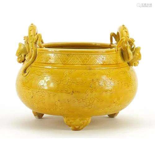 Chinese porcelain yellow glazed tripod censer with dragon ha...