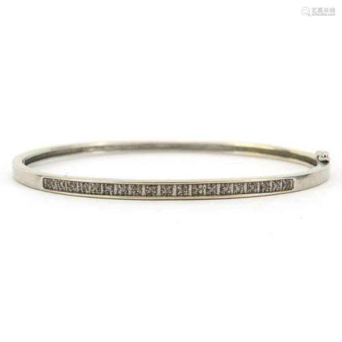 9ct white gold diamond hinged bangle housed in an Arcade Jew...