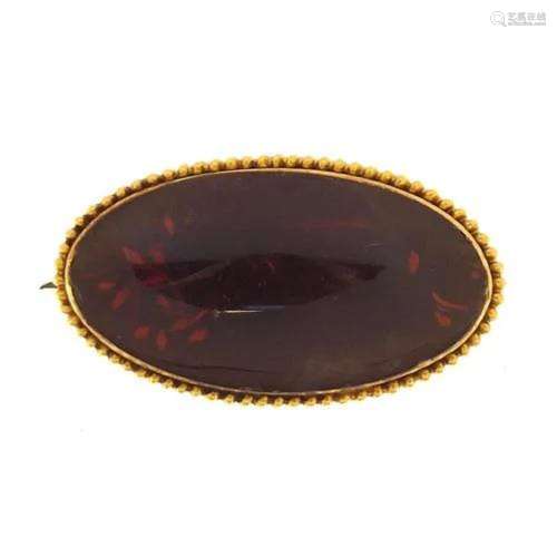 Unmarked gold amber brooch, (tests as 15ct+ gold) 3.2cm wide...