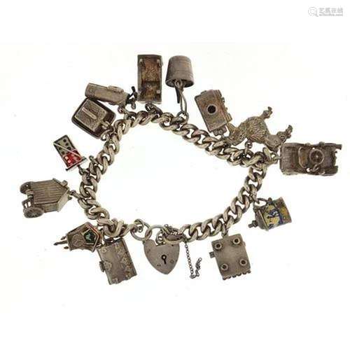 Silver charm bracelet with a selection of mostly silver char...