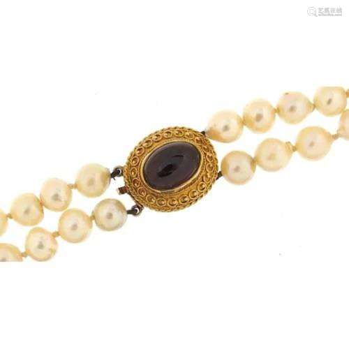 Two row cultured pearl necklace with 9ct gold cabochon garne...