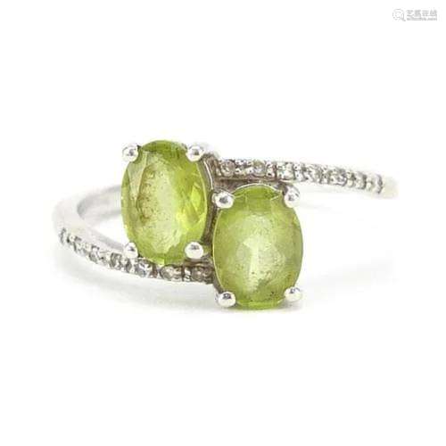 9ct white gold peridot and diamond crossover ring, size N, 2...