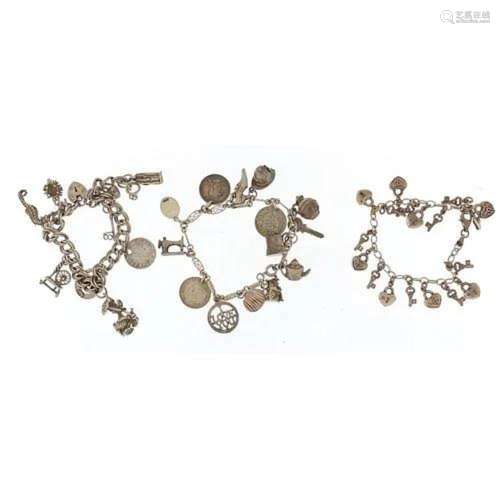 Three silver charm bracelets with a selection of mostly silv...