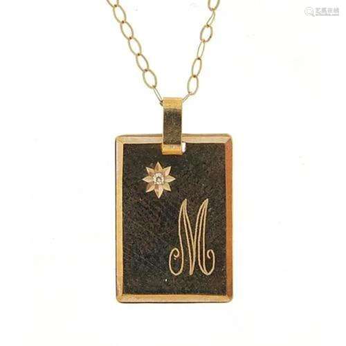 9ct gold diamond pendant engraved with initial M on a 9ct go...