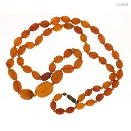 Butterscotch amber coloured graduated bead necklace, the lar...