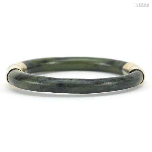 Chinese green jade bangle with gilt metal mounts, 7.5cm in d...