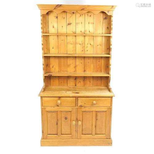 Pine dresser with open plate rack above two drawers and a pa...