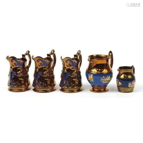 Five Victorian lustre jugs including one hand painted with f...