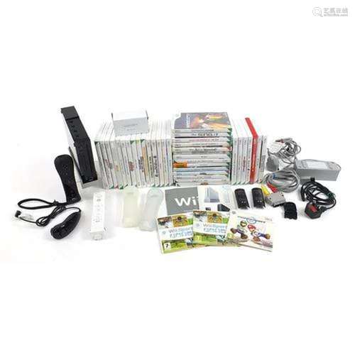 Black Nintendo Wii games console with controllers, accessori...