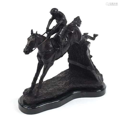 Large patinated bronze study of a jockey on horseback jumpin...